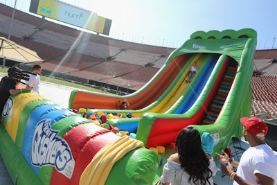 General Mills’ activation invited guests to slide down an inflatable slide—mimicking a roll of Fruit by the Foot—into a pit of foam that resembled Gushers fruit snacks. Participants were given a digital photo of their ride, along with candy, fidget spinners, and branded headphones.