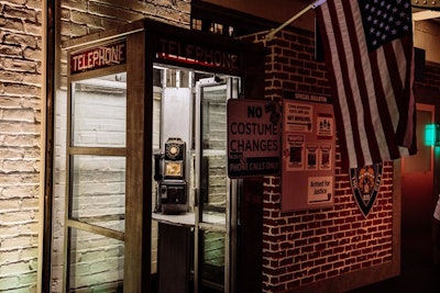 A throwback phone booth with more clever signage sat outside of a makeshift police station.