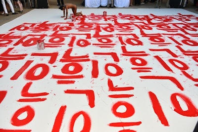 Performance artist Dana Davenport's 'live' work, painted in the nude, was featured in two locations: the main silent auction tent (pictured) as well as within the dinner tent. The text in the former read 'Black Person' while, in the latter, it read 'White Culture.'
