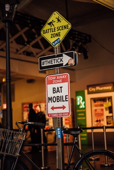 MKG altered familiar street signs with messages related to the show. At the City Pharmacy window, attendees were offered X-ray vision exams, Kryptonite vaccines, and cape rash cream.