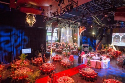 The Grace de Monaco Rose inspired the rosy-hued decor on the Filene Center stage, with pink linens by DC Rental and rose floral arrangements from Karin's Florist. Projection screens showed scenes from Monte Carlo, and guests gathered around the central circular bar, which boasted its own fountain.