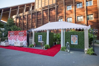 Oversize graphic roses in a red, pink, and white ombre colors covered the step-and-repeat, which was moved inside during the dinner for photo ops.
