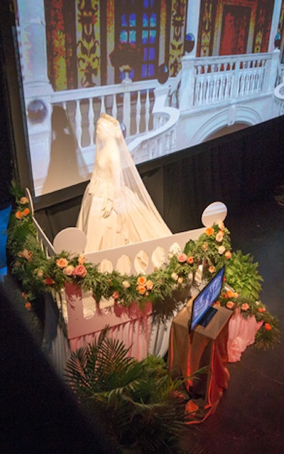 The Monaco-theme decor included a replica of Princess Grace Kelly’s dress for her 1956 wedding to Prince Rainier III. The gown was on loan from a Grace Kelly fan from Maryland, who commissioned the piece as a gift to the East Falls Historical Society in Philadelphia to celebrate what would have been the royal couple’s 60th wedding anniversary. Video footage of the wedding played on a screen while the dress stood on a staircase designed to evoke Princess Grace’s wedding day.