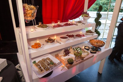 A catering display presented seasonal fruits, cheeses, antipasto, and Monaco’s national dish, Barbagiuan (front left)—a savory small pastry similar to a dumpling or fritter often filled with Swiss chard and ricotta. The evening’s caterer, Design Cuisine, collaborated with Hôtel de Paris Monte-Carlo executive chef de cuisine Franck Cerutti to recreate his signature Barbagiuan recipe for the occasion.