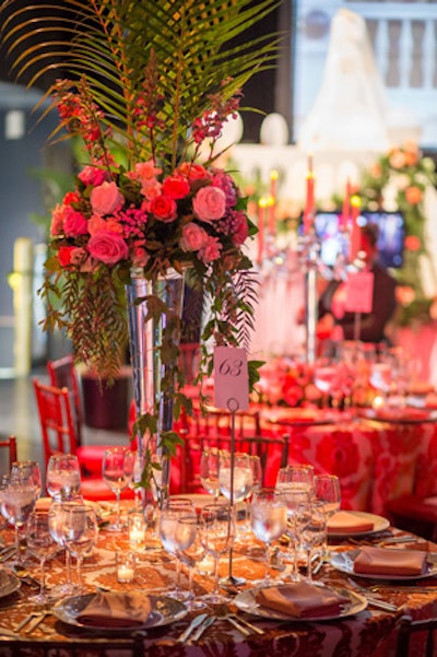 Karin’s Florist placed roses throughout the entire space, from high and low centerpieces to a market cart with long-stemmed roses for guests to take home.