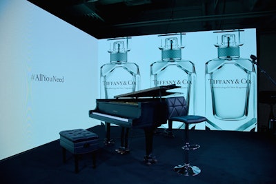 In the lead-up to the evening's special live performance, MKG erected a custom platform stage flanked by a seamless video screen comprising two panels that flashed imagery and teaser stills of the new fragrance.