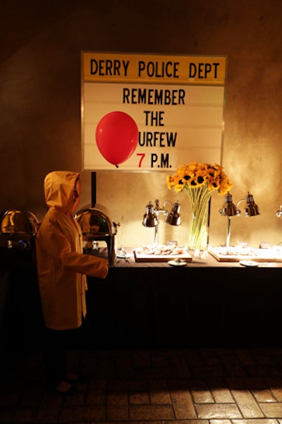 The Georgies roamed the party with their red balloons, occasionally popping up behind guests to scare them. Signs from the movie’s Derry Police Department further immersed guests, while sunflowers—another nod to the film—provided by CJ Matsumoto featured prominently in the event decor.
