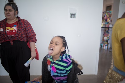 Child enjoying LP Edible Orange Flavored Bubbles.