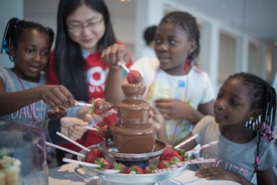 Children Enjoying LP Heated Chocolate Fountain with Chilled Strawberries.