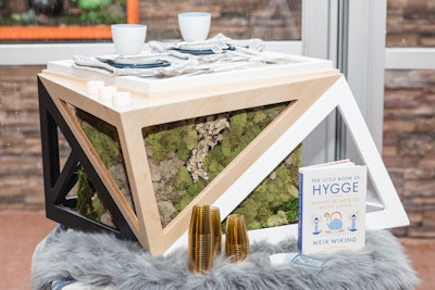 The trendy Danish concept of hygge, or happiness and well-being, inspired designers Michele Alfano and Tiago Fonseco to use elements of Copenhagen, such as a geometric, light-colored structure that could serve as a table.