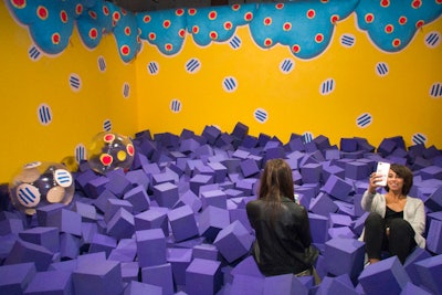 Brooklyn-based visual artists Chiaozza designed “Cloud Pool” where guests could jump into a pile of 1,980 purple foam blocks and colorful inflatables.