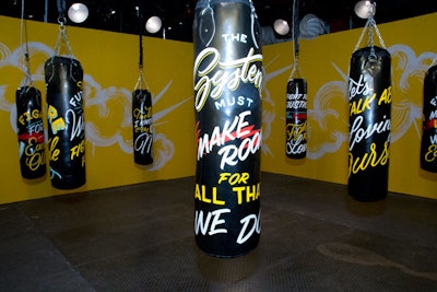 Illustrator Jen Mussari designed hand-painted punching bags and gloves for “The Future Is Female” installation. Electronic music artist Madame Gandhi created beats in the space that guests could turn on by punching the bags.