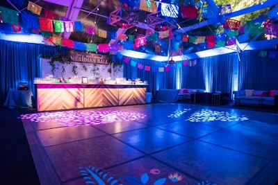 After dinner, guests headed to the dance floor, in a tent from Select Event Group that was decorated with papel picado (decorative Mexican craft paper cutouts) and rustic light fixtures.