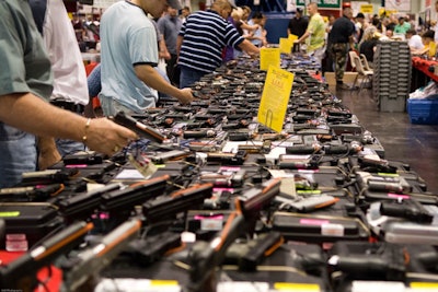 Attendees browse handguns on display at the George R. Brown Convention Center in Houston.