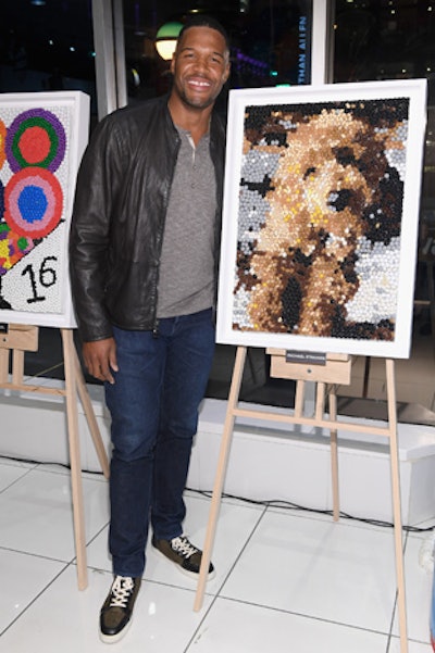 Michael Strahan posed with the candy mosaic of his dog Enzo, which was made using jelly beans and M&Ms. Proceeds from the sale of the piece will benefit St. Jude Children’s Research Hospital.