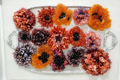 Martha Stewart’s floral candy mosaic was crafted using M&Ms, jelly beans, licorice wheels, licorice, gummy berries, gummy bears, sour patch kids, orange slices, rock candy, gummy worms, and candy wrapper foil.