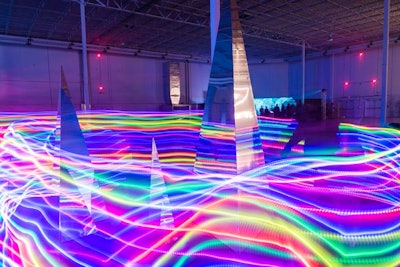 An LED hula hooper lent a spectrum of light to the reflective III Points sculpture by Dalva.