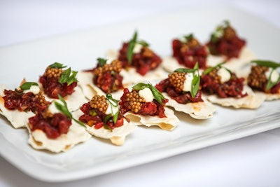 During the holidays, D’Amico Catering serves a bison tartare with harissa, pickled mustard seed, Greek yogurt, and lavos as an hors d’oeuvre. The pickled mustard seeds add color and a pop of flavor.