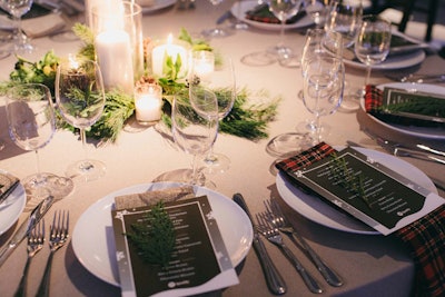 The dining table at the Spotify event featured classic plaid napkins and evergreen sprigs.