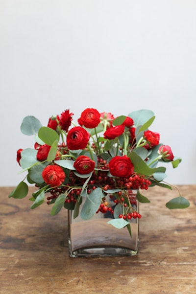 Interior Foliage Design's Matthew Schechter says to expect blooms in solid colors this season. Think red ranunculus and cranberry branches paired with silver vases and votives.