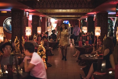 Cocktail servers dressed as 1920s flappers added to the speakeasy atmosphere.