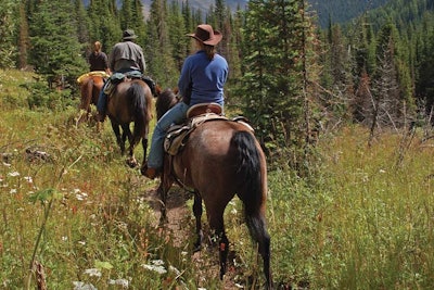At the Paws Up ranch in Montana, spousal programs include activities such as horseback riding.