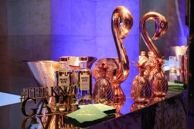 Bar decor included copper pineapple and swans, green napkins with the event tile, and a copper hashtag sign.