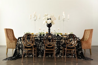 This sparkly dining table setup features the Black and Gold Koi linen, from $15 to $95; the Rose Gold Phoenix Chair, $12.95; and the Gold High Back Wing Chair, $150, from Nuage Designs.