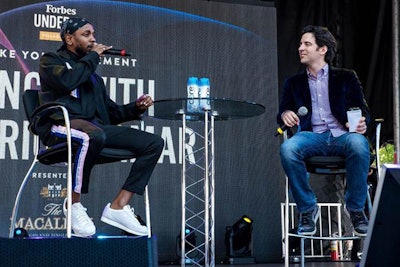 Kendrick Lamar spoke with Forbes senior editor Zack Greenburg about his successes and failures from a stage at the Village, the event's central hub.