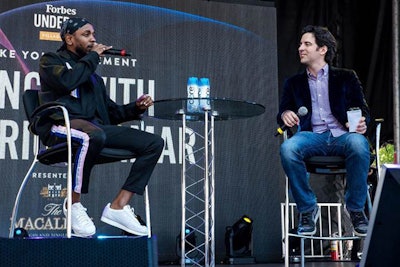 Kendrick Lamar spoke with Forbes senior editor Zack Greenburg about his successes and failures from a stage at the Village, the event's central hub.