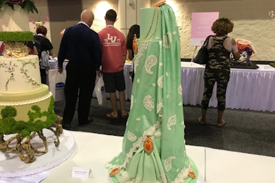 This wedding cake was made with edible fabric and lace to look like a sari, a garment worn by many women in India.