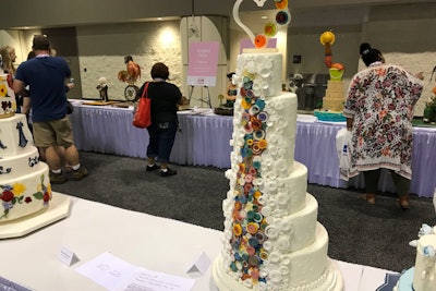 This entrant used powdered food color and vegetable oil to paint wafer paper, and then a bamboo skewer to create tight rolls for this wedding cake.