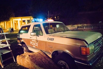 A Hawkins Police Department car added to the party’s immersive environment.