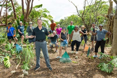 Communication Network attendees take a break from their annual meeting at Fontainebleau Miami Beach Hotel to clean up post-storm debris at Zoo Miami.