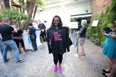 Visitors to the Will & Grace photo booth received T-shirt and towel giveaways.