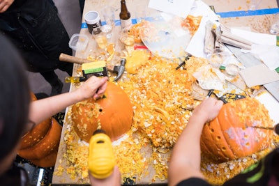 A crowd of 275 watched the architectural pros get covered in pumpkin guts.