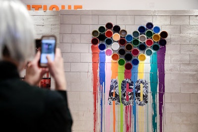 A wall installation of paint cans dripping a rainbow of colors provided a unique photo op for guests.