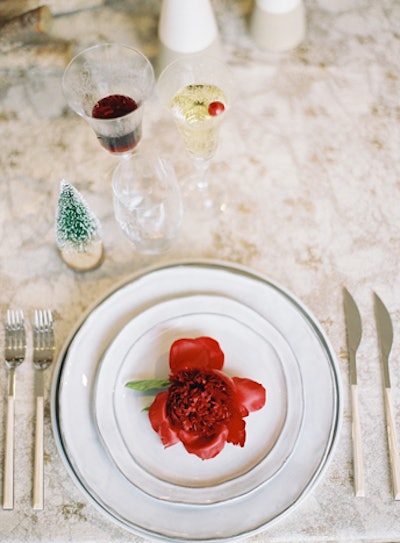 Nuage and Crokos kept the tablescape simple, with white serveware from the Tabletop Company and additional flowers. Tiny snow-capped pine trees added to the wintery vibe.
