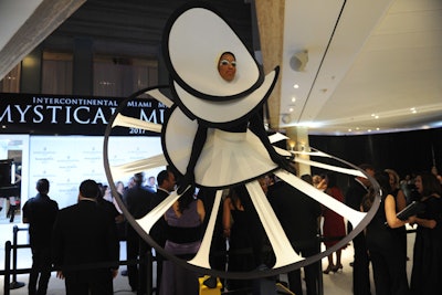 Performers in the arrivals area wore sculptural black and white ruffled mini dresses.