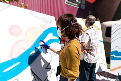 For one of the activities, participants spray painted a mural that had been pre-stenciled with designs.