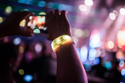 At the closing party, guests wore LED wristbands from PixMob that change color in sync with the performance by OneRepublic.