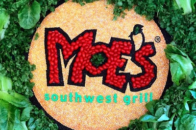 The Moe's Southwest Grill logo made out of corn, peppers, lettuce, cilantro, and other ingredients fills one wall of the truck.