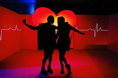 The 'Throb' room provided attendees with a photo op in front of a giant heart that throbbed to the beat of music, creating a rhythmic monitor effect on the surrounding walls.