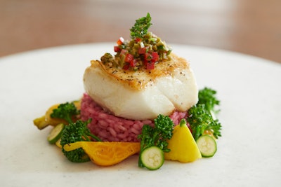 For an entree, guests will dine on Mediterranean Chilean sea bass served with red beet parmesan risotto, Castelvetrano olive tapenade, broccolini florets, golden stripe baby beets, yellow squash, and zucchini.