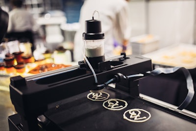 Wolfgang Puck Catering also offered 3-D food printing throughout the evening. Blinis were topped with the catering company's logo, along with smoked salmon and dill crème fraîche. “It was a fun play on science and engineering,” explained chef Drew Swanson.
