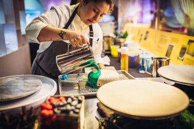 Every half hour, Wolfgang Puck pastry chefs hosted a live cake-decorating session. Mirror glaze was poured on the cakes, and finished with intricate decorations. The cakes were then displayed on a vertical display wall, and guests were given smaller versions to taste.