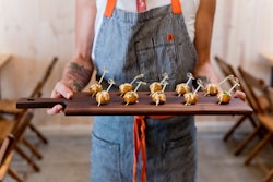 Full-service Austin catering company the Peached Tortilla specializes in corporate parties and social events. New menu items include twists on Korean cuisine like kimchi arancini 'lollipops,' which are a play on a traditional arancini ball. This popular passed appetizer runs $3.50 per person. And for a main entree, the Peached Tortilla serves Korean braised short ribs, served on a bed of cauliflower puree with a demiglace. The $27-per-person meal includes a side and salad, along with bread and butter.