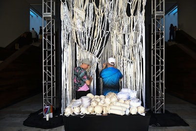 “Our intention was to have elements of art woven throughout the experience,” Arak-Kanofsky said. “We invited our inaugural artists in residence to bring a live performance aspect to the event decor.” Ken Jones Jr. and Ron Morris collaborated on a 21-foot-tall “MACROme” (named that because of its size) macramé piece for the entrance of the convention center. The piece evolved over the course of the conference and was completed in time for the gala.