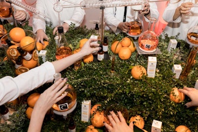 Kiehl's wanted the event to evoke the brand's touchpoints of nature, science, and service. Bars were covered in greenery, while oranges tied into the vitamin C theme. Orange-infused cocktails were poured from beakers and test tubes.