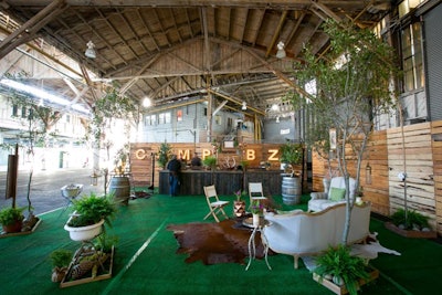 Rustic glamping-inspired decor was designed to complement the pier’s exposed wood ceiling. In one section rentals by Bright Event Rentals, greenery and flowers by Hunt Littlefield, and catering by Betty Zlatchin Catering offered a stylish place for guests to relax.